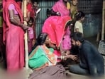 Family members mourn the loss of their after a speeding car ploughed into a group of devotees performing a roadside puja, in Supaul district of Bihar. 