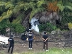 Police officers inspect the scene where the body of missing person Jang Mi-ran was discovered at a palm tree farm in Jeju on the Jeju island, South Korea