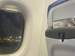 Man shares airplane view with family.