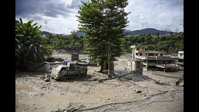 A truck and structures stand partially submerged in a thick layer of mud and debris following flash floods at Beni Ghat area, in Dhading district, Nepal, on Wednesday. (PTI) A truck and structures stand partially submerged in a thick layer of mud and debris following flash floods at Beni Ghat area, in Dhading district, Nepal, on Wednesday. (PTI)