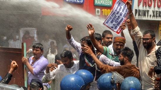 Police personnel use a water cannon on protestors as they raise slogans during a Mukhyamantri Gherao march over education and employment issues, organised by the Chhatra Yuva Sangharsh Morcha, in Patna, Bihar on Tuesday.
(Pappi Sharma/ANI)