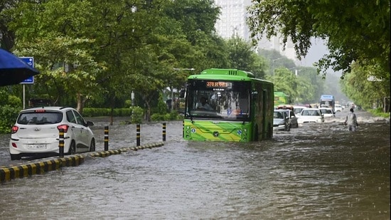 Commuters make their way through the waterlogged Baba Kharak Singh road after heavy rainfall, in New Delhi, Tuesday, Aug. 25, 2026. (PTI)