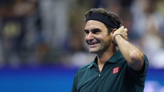 Roger Federer of Switzerland reacts while playing in the exhibition doubles match with John McEnroe against Andy Roddick and Andre Agassi