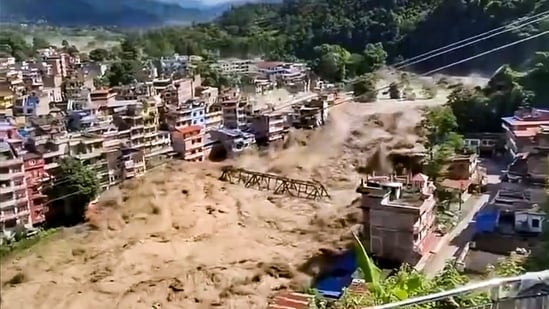 Nepal floods: In this screengrab from a video posted on Aug. 26, 2026, Floodwater flows across a residential area, in Nepal. 