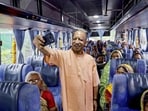 Chief minister Yogi Adityanath takes a selfie during the launch of the ‘Lokmata Ahilyabai Matrushakti Yatra’ scheme, in Lucknow on Wednesday. (PTI PHOTO)