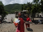 Women carry belongings from their damaged homes after a flash flood and a mudslide, in Galchhi, Nepal, August 27, 2026.(REUTERS)