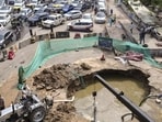 Two service lanes remain barricaded after a sewer drain collapse created a large sinkhole, triggering congestion and panic among commuters. (PTI)