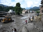 Workers use excavators to clear the mud following flash floods in Trishuli in Nepal’s Nuwakot district on Thursday. (AFP)