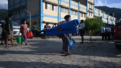 Residents leave after receiving utility aid at a hospital turned temporary shelter after flash floods in the Devighat area of Nepal's Nuwakot district on August 27, 2026. (AFP)