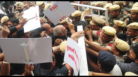 Leader of the Opposition Bhupinder Singh Hooda, along with other Congress MLAs, being stopped at the assembly entrance, in Chandigarh on Thursday. (Keshav Singh/HT)