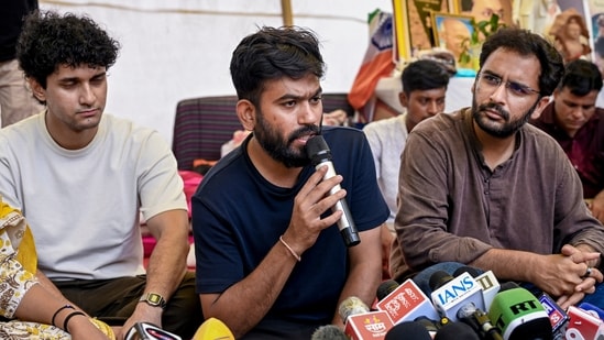 Cockroach Janta Party (CJP) founder Abhijeet Dipke addresses a press conference as party spokepersons Saurav Das and Ashutosh Ranka look on, amid the ongoing protest over NEET paper leak issue, at Jantar Mantar.