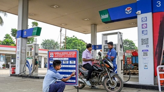 A worker updates prices at a petrol pump in Nadia, West Bengal.