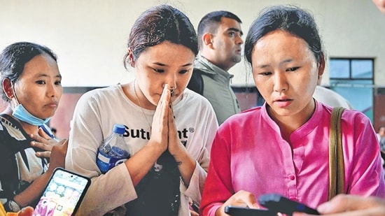 Family members check a list of people who were injured after the flash floods, at Bir Hospital in Kathmandu, Nepal on Wednesday.