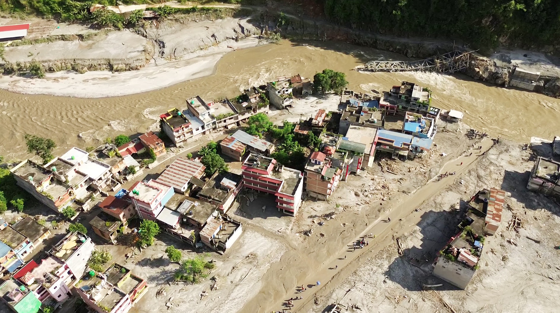 A drone view of the devastation in Devighat area following a mud-laden flash flood caused by an outburst in the Bhotekoshi River, in Nuwakot on Thursday. (ANI Video Grab) A drone view of the devastation in Devighat area following a mud-laden flash flood caused by an outburst in the Bhotekoshi River, in Nuwakot on Thursday. (ANI Video Grab)