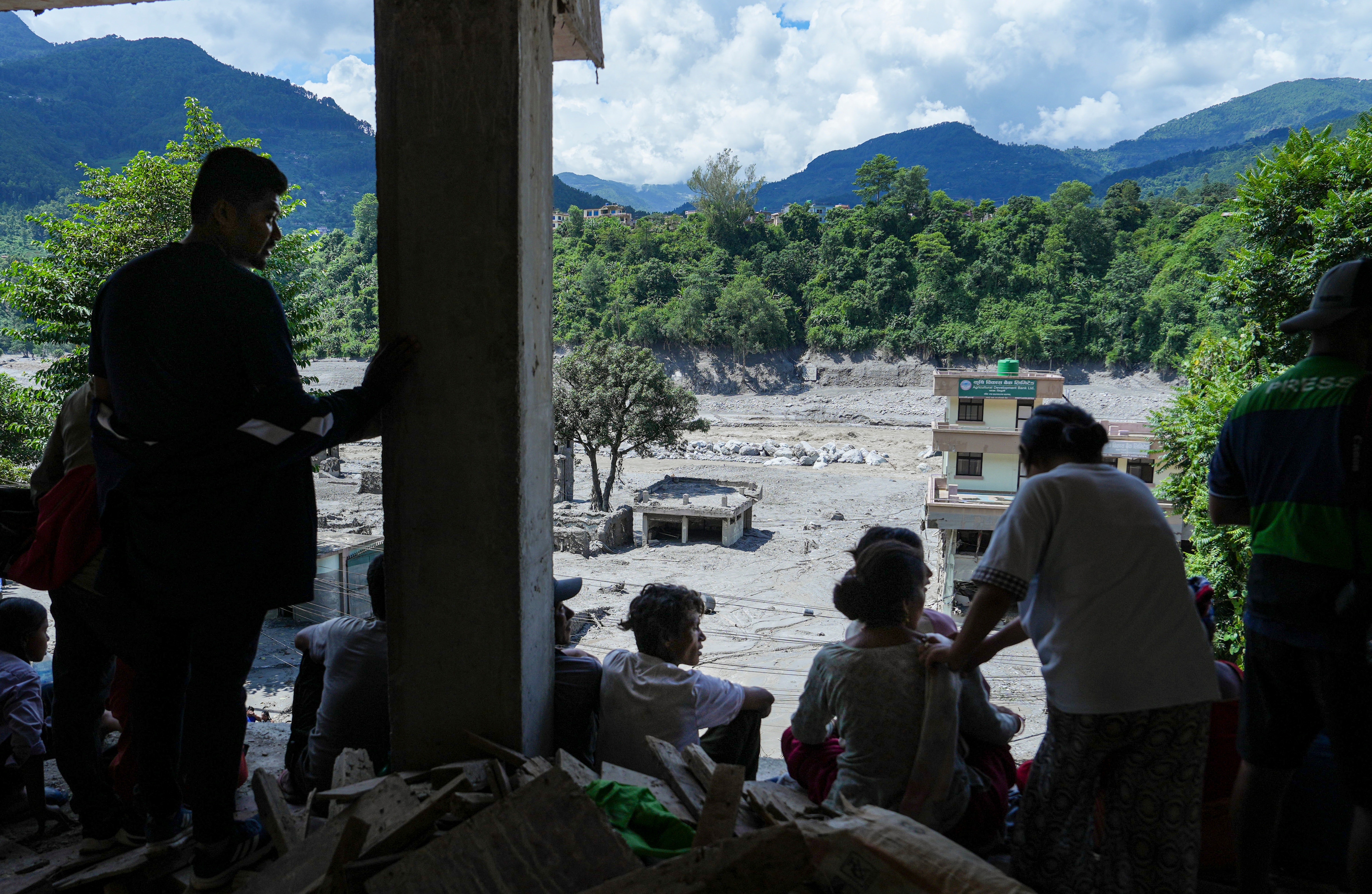 People gather during a search and rescue operation in the aftermath of the devastating flash flood, at Trishuli Dam, in Nuwakot district, Nepal. (PTI) People gather during a search and rescue operation in the aftermath of the devastating flash flood, at Trishuli Dam, in Nuwakot district, Nepal. (PTI)