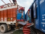 Workers unload sacks of onions from the 