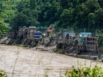 A swollen river flows through a flood-affected area in the aftermath of the flash floods, in Dhading, Nepal.