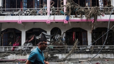 A man walks past a damaged house after a landslide, in Devighat, Nuwakot district, Nepal. (REUTERS)