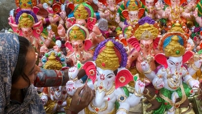 Gram it: An artisan gives final touches to an idol of Lord Ganesh ahead of the Ganesh Chaturthi festival, in Gurugram. This year, the 10-day festival will begin from September 14. (Photo: PTI)