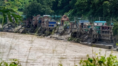 A swollen river flows through a flood-affected area in the aftermath of the flash floods, in Dhading, Nepal. (PTI Photo)