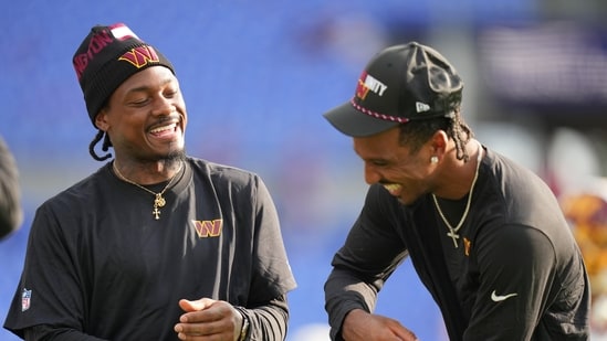 Washington Commanders wide receiver Stefon Diggs, and quarterback Jayden Daniels share a laugh before an NFL preseason football game in Baltimore.