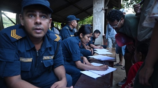Nepal police collect details of missing people from relatives as they wait at Trishuli army camp, in Nepal's Nuwakot district on August 28, 2026. China and Nepal warned of fresh flooding risks, complicating rescuers' search for more than 1,400 people missing after a deadly deluge and landslides swept away entire villages along their remote Himalayan border. (Photo by Arun SANKAR / AFP) (AFP)