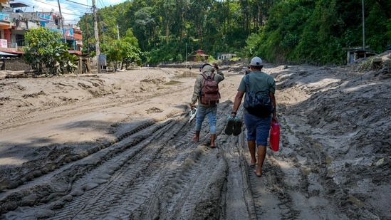 Nepal floods LIVE: People walk barefeet on mud and silt washed along the flash floods, in Dhading district, Nepal, Friday, Aug. 28, 2026. Nepal floods LIVE: People walk barefeet on mud and silt washed along the flash floods, in Dhading district, Nepal, Friday, Aug. 28, 2026.