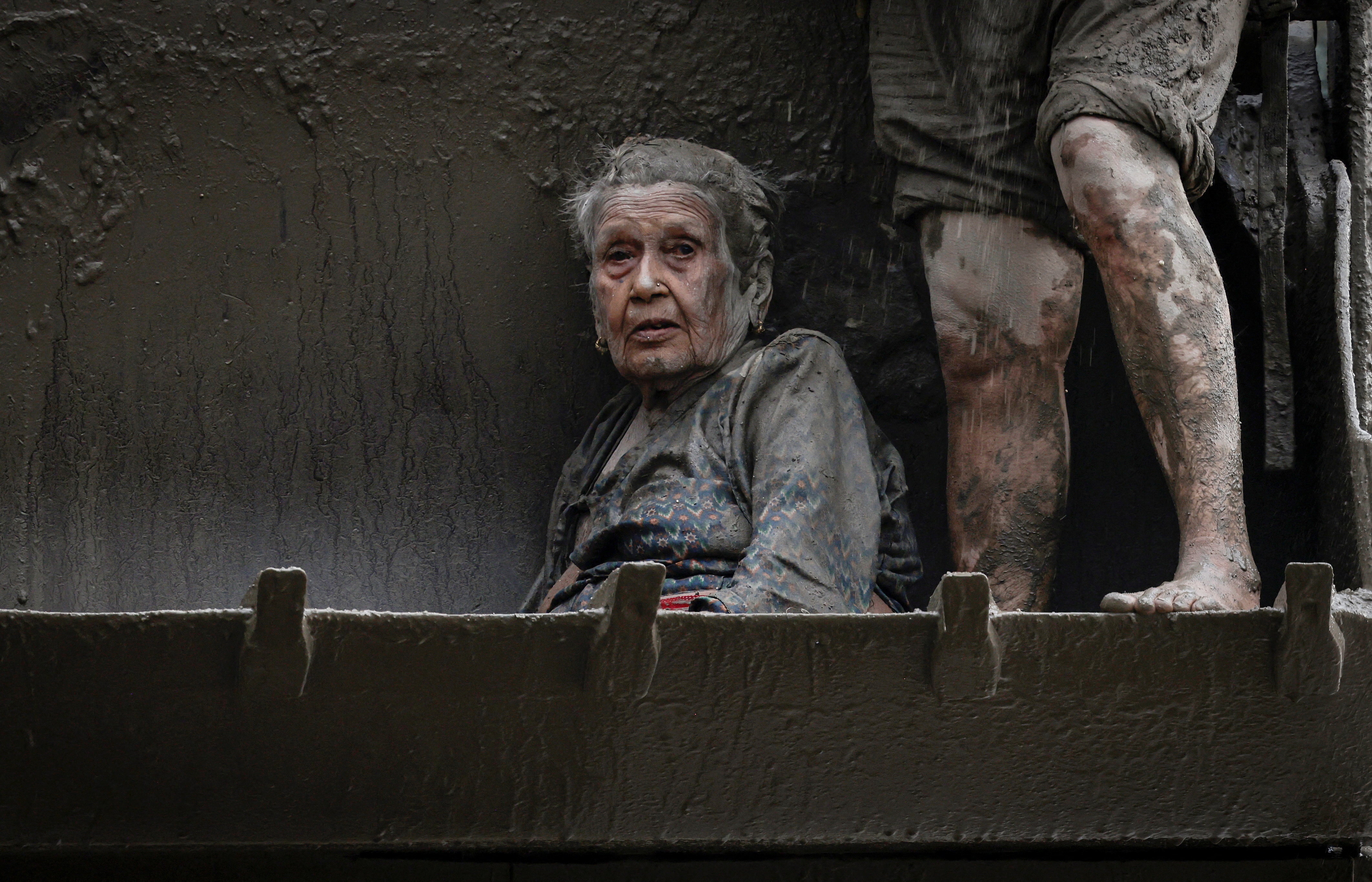 An elderly survivor is transported to a safer place in heavy machinery following flash flood and mudslide at Trishuli in Nuwakot district. (Reuters)