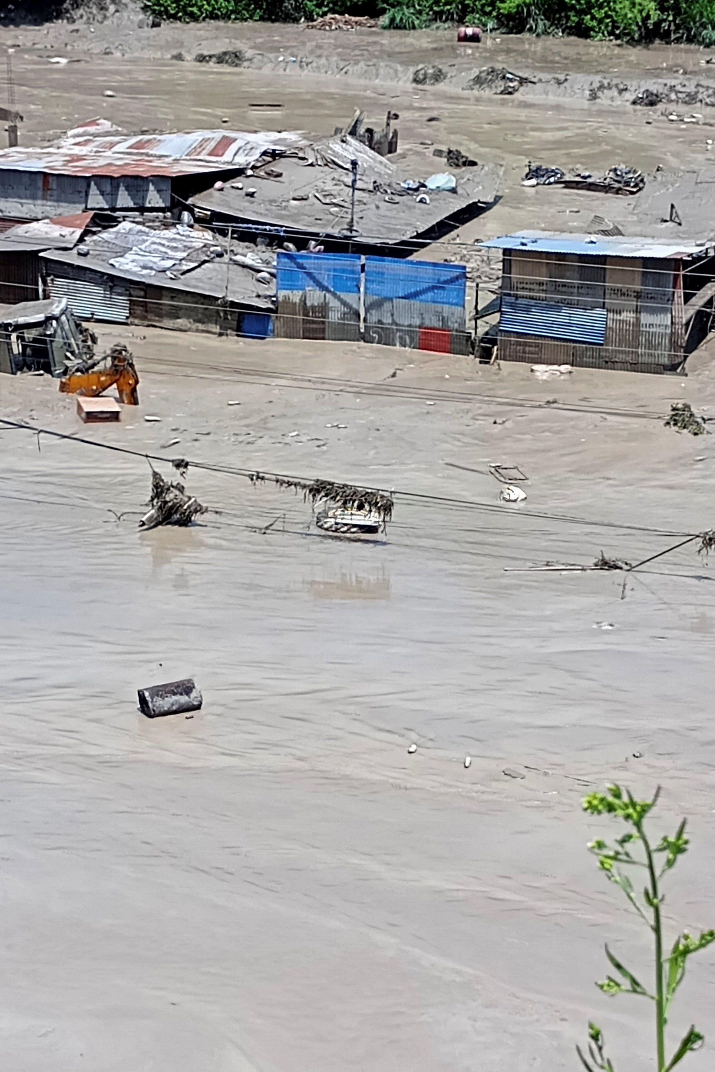 Damaged property and flooded roads in Galchhi, Dhading district. (Reuters)