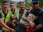 Police officers carry a survivor to a safer place following a flash flood at Trishuli in Nuwakot district, Nepal, August 26, 2026. 