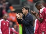 Liverpool's manager Andoni Iraola applauds supporters at the end of the match.