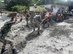 Dhading: Army personnel shovel thick mud and debris to clear houses inundated by severe flash floods, in Dhading district, Nepal. (PTI)