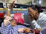 Zoyal Ghale, 8, who was airlifted from Rasuwa, speaks with his mother Matti Maya Tamang, inside a hospital in Kathmandu, Nepal.(REUTERS)