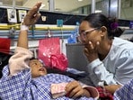 ఆసుపత్రిలో తల్లితో మాట్లాడుతున్న బాలుడు..(REUTERS)