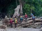 A Nepal Army official conduct a search and rescue operation along side a river area at Charaudi, in Dhading district, Nepal.
