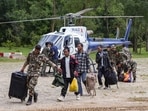Army personnel assist people as they disembark from a rescue helicopter at an army camp in Trishuli, Nuwakot district, Nepal. Army personnel assist people as they disembark from a rescue helicopter at an army camp in Trishuli, Nuwakot district, Nepal.