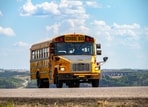 Yellow school buses were chosen for their visibility and contrast with black lettering, enhancing safety for child transportation. 