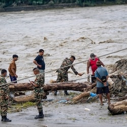 Nepal-Tibet flood LIVE:  A Nepal Army official conduct a search and rescue operation along side a river area at Charaudi, in Dhading district, Nepal.