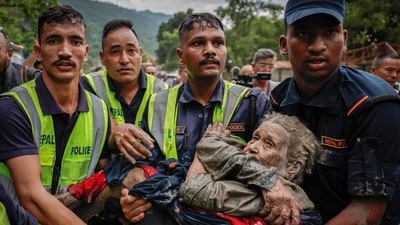 Police officers carry a survivor to a safer place following a flash flood at Trishuli in Nuwakot district, Nepal, August 26, 2026. (REUTERS/Navesh Chitrakar)