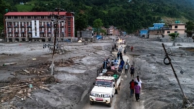 A drone view of people walking on a road and houses in mud, following deadly flash floods and mudslides at Devighat, Nuwakot district, Nepal, (Photo for representation) (REUTERS)