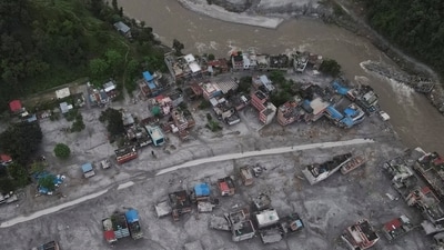 Nepal floods LIVE: A drone view shows houses covered in mud and the broken bridge after the flash floods and mudslide, at Devighat, Nuwakot district, Nepal.