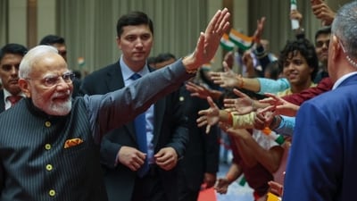 PM Modi greets the Indian community at an event in Tashkent.