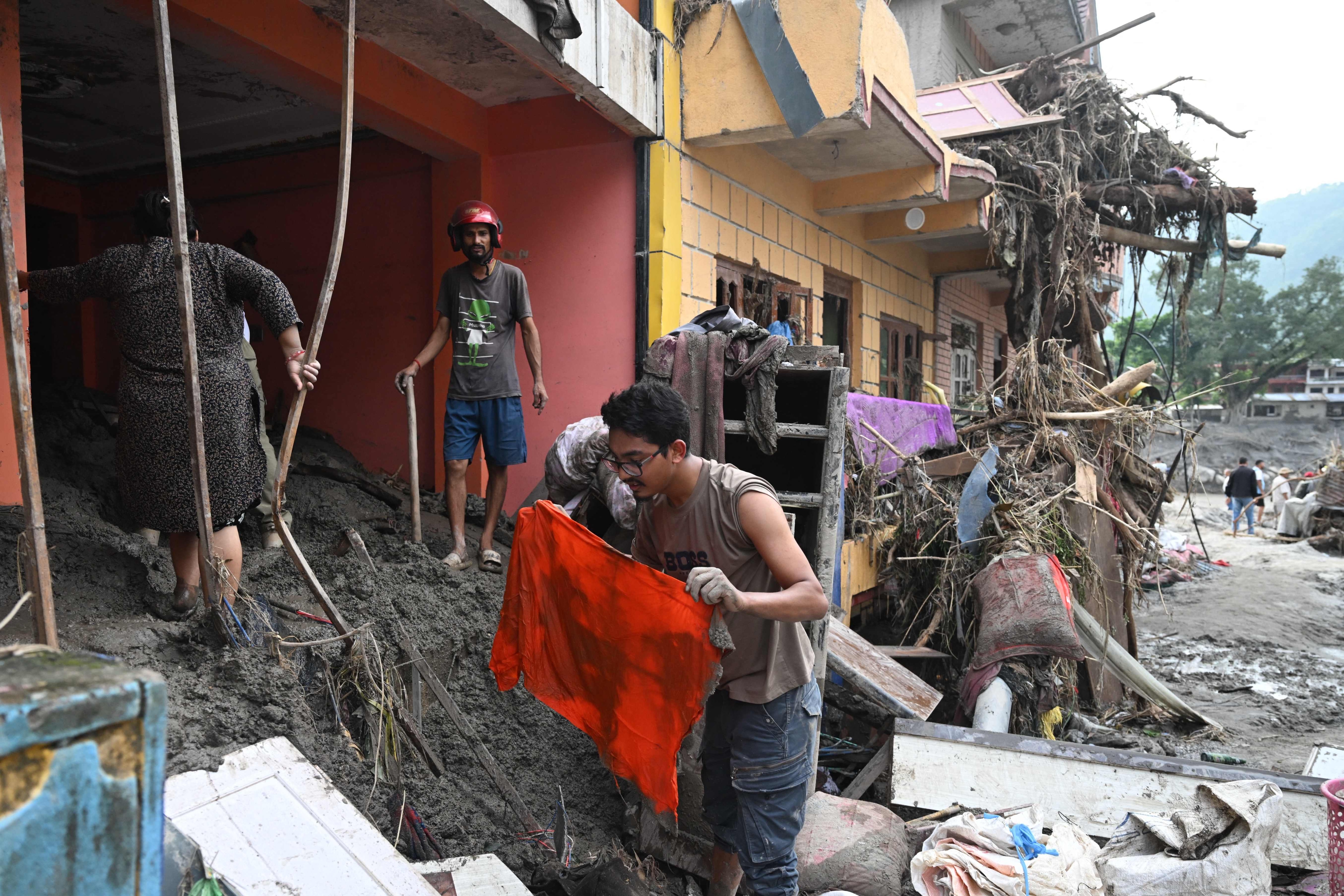 People salvage usable materials from their houses deluged in sludge following flash floods at Devighat in Nepal�s Nuwakot district on August 28, 2026. More than 1,400 people are missing and at least 552 have been killed after a devastating, tsunami-like wall of water gouged a path through the border region between Nepal and Tibet, sweeping away entire villages. (Photo by Arun SANKAR / AFP) (AFP) People salvage usable materials from their houses deluged in sludge following flash floods at Devighat in Nepal�s Nuwakot district on August 28, 2026. More than 1,400 people are missing and at least 552 have been killed after a devastating, tsunami-like wall of water gouged a path through the border region between Nepal and Tibet, sweeping away entire villages. (Photo by Arun SANKAR / AFP) (AFP)