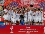 Gold medal winners, Germany, celebrate with the trophy on the podium during the World Cup Field Hockey competition in Wavre, Belgium(AP Photo/Geert Vanden Wijngaert)