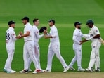 England's Harry Brook and Joe Root celebrate after the match