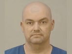 Benjamin Larson is charged with stalking after police found human skulls and serial killer memorabilia in his Wisconsin home