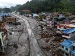 Nepal flash floods live updates: A drone view shows people walk on a road and houses covered in mud following deadly flash floods and mudslides, in Devighat, Nuwakot district, Nepal.