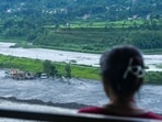 Nuwakot: People sit near a damaged structure as they look on the flood-ravaged Trishuli river in the aftermath of flash floods, at Trishuli market, in Nuwakot district, Sunday, Aug. 30, 2026.