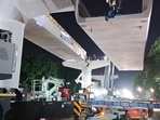 The first girder was lifted onto pillars 26 and 27 using 400-tonne and 600-tonne hydraulic cranes late Friday night. (HT)