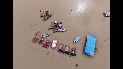 An aerial view of floating boats near the Sangam Ghat, inundated by the swollen waters of the Ganga and Yamuna rivers, in Prayagraj on Sunday. (ANI) An aerial view of floating boats near the Sangam Ghat, inundated by the swollen waters of the Ganga and Yamuna rivers, in Prayagraj on Sunday. (ANI)